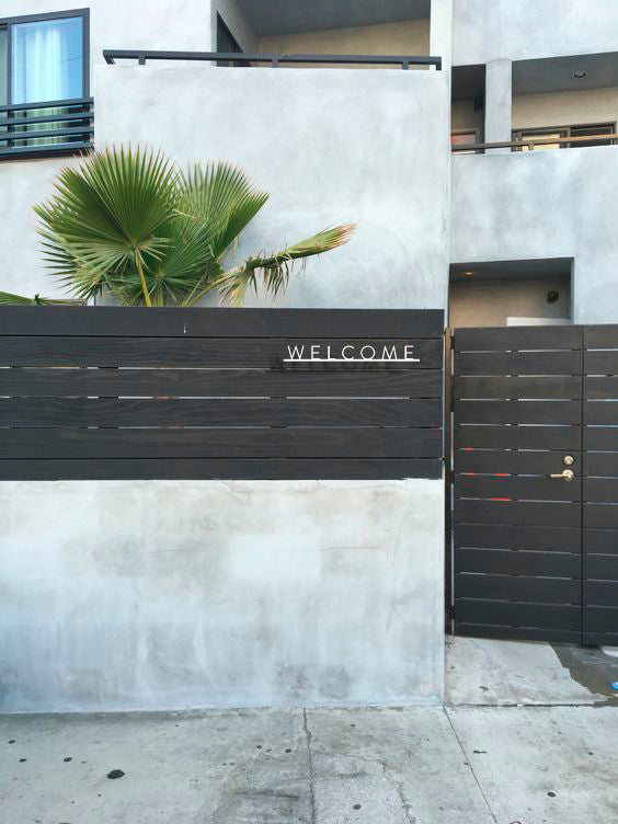 Custom metal sign displaying text in a sleek, modern font. Floating metal letters mounted on a textured background. Minimalist design suitable for home or business decor.